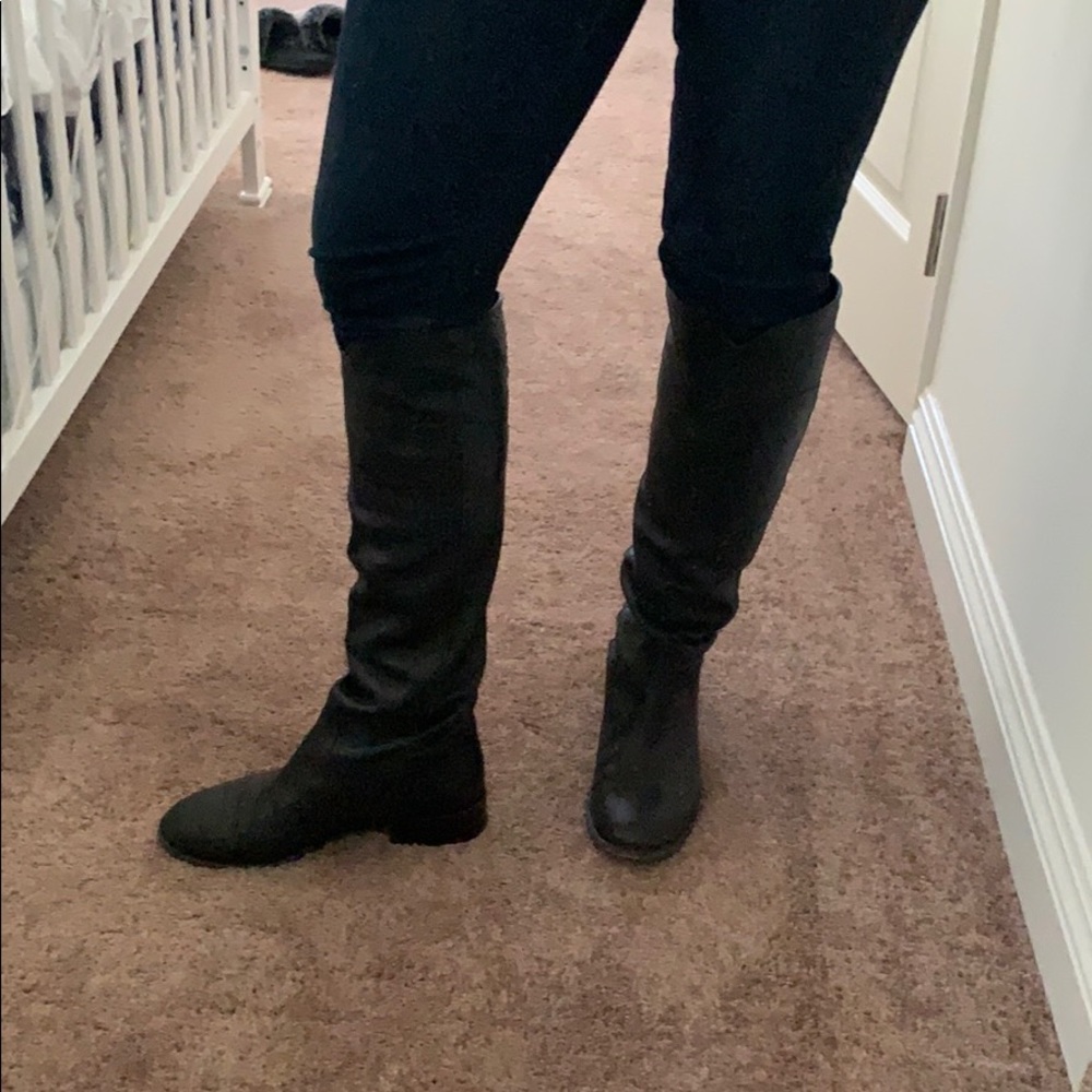 Chanel riding boots with Chanel logo on back.